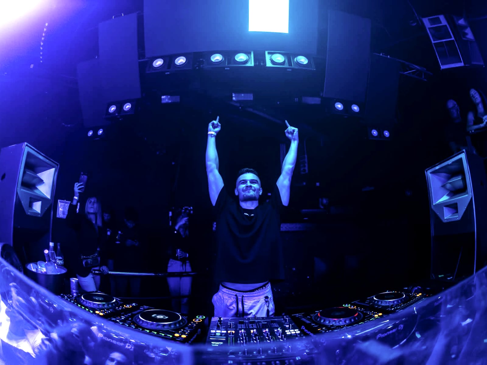 Fisheye view of A-RIZE behind the mixer, the room washed in deep blue